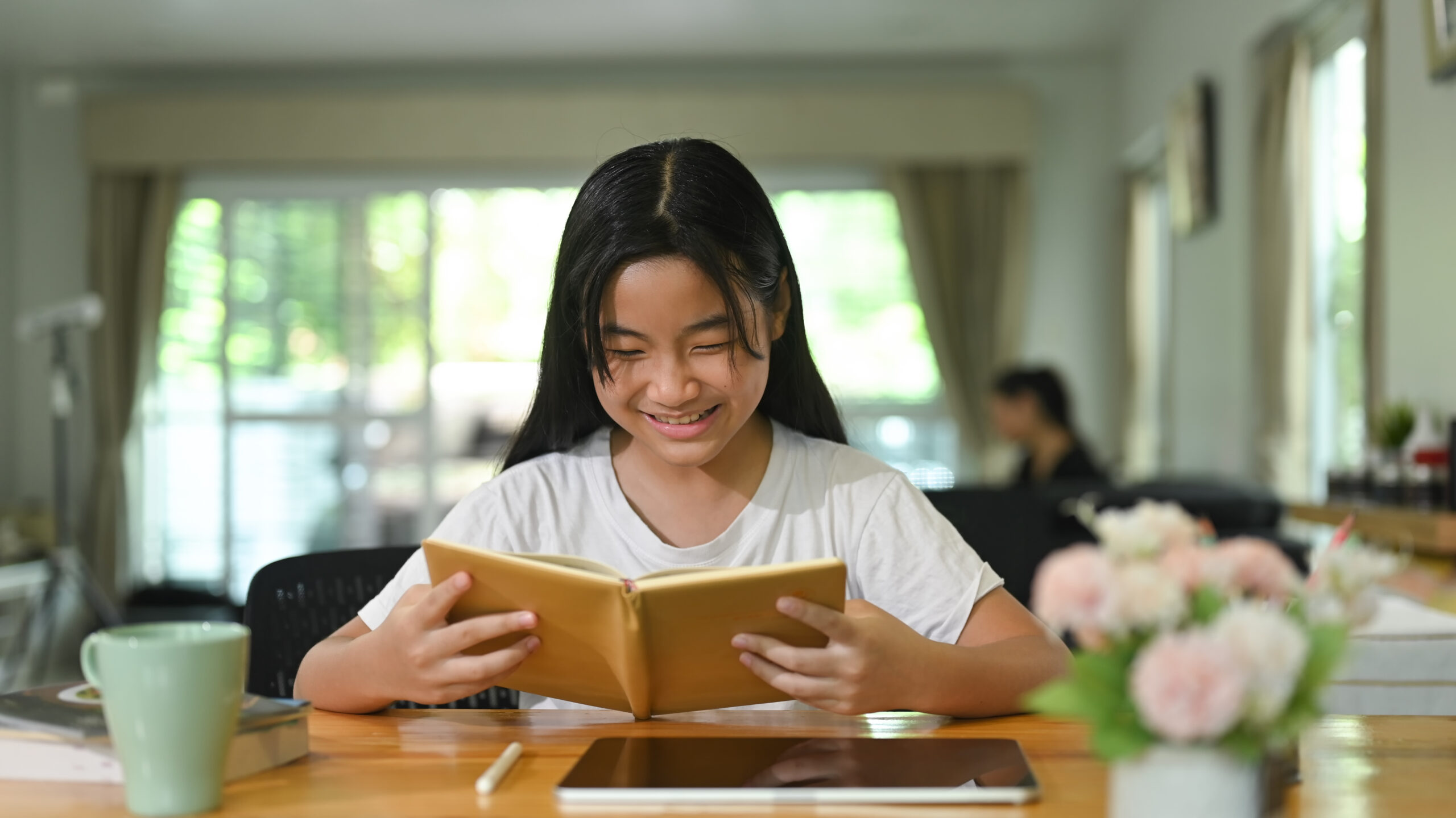 Secondary 3 student reading a book at a study desk, representing the critical reading, analytical thinking, and independent learning skills needed before O-Level English.