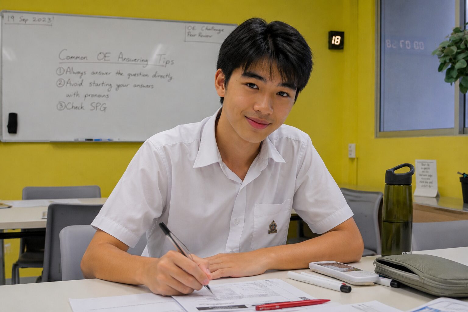 Secondary school student practising English essay writing in a classroom in Singapore